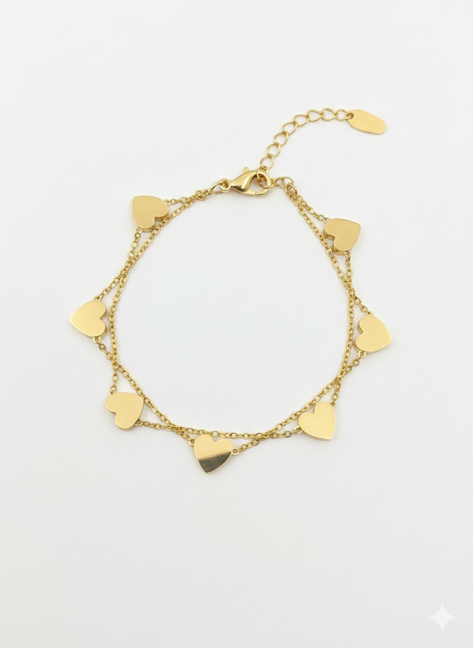 Gold bracelet with heart-shaped charms on a white background