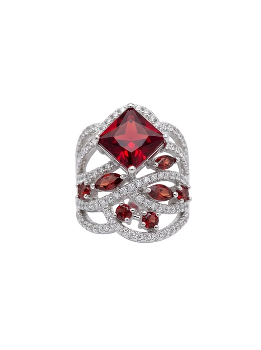 Ring with a prominent red gemstone on a white background