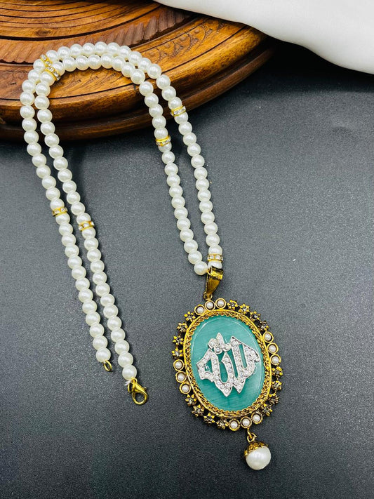Pearl necklace with a turquoise pendant on a dark surface
