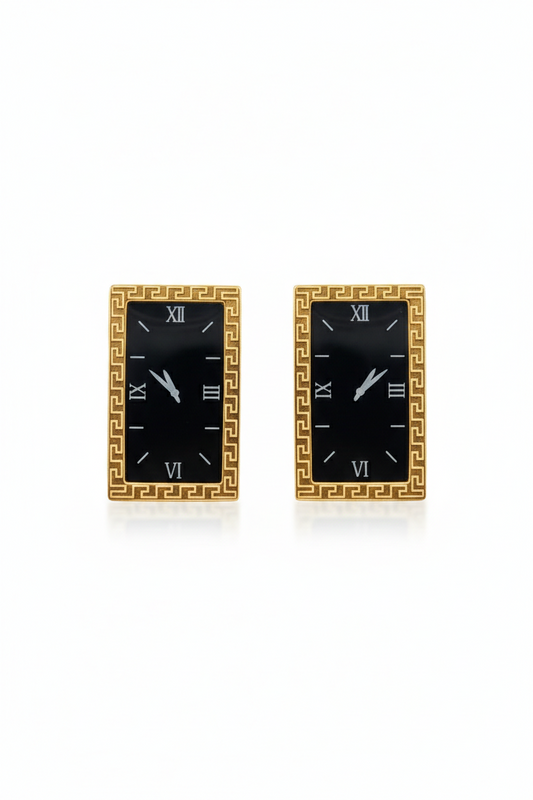 Pair of gold-framed black square earrings on a white background