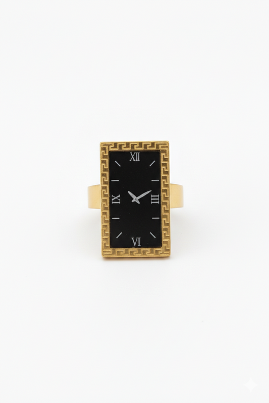 Gold-framed black rectangular watch on a white background