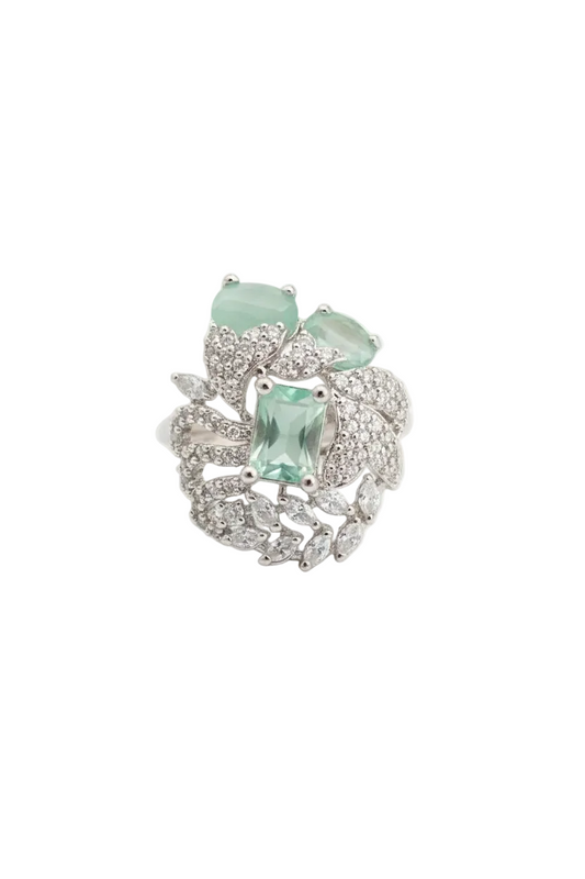 Silver ring with green gemstones on a white background