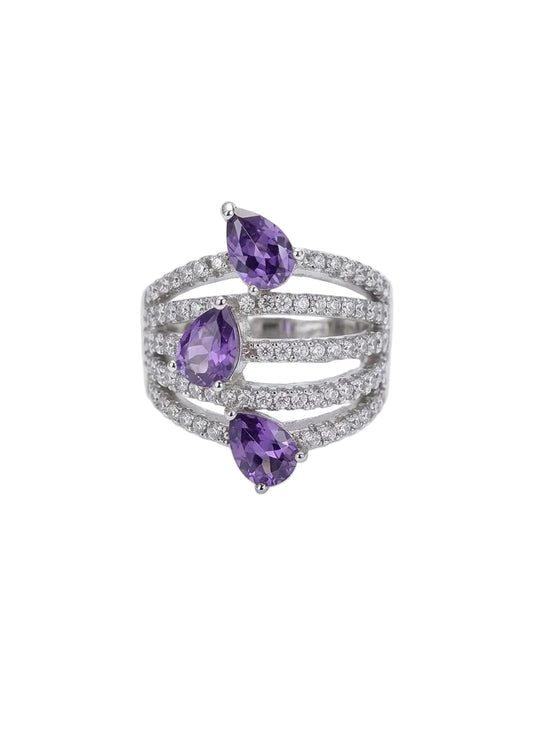 Silver ring with purple gemstones on a white background